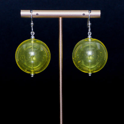 Lime yellow handblown glass earrings against a black background