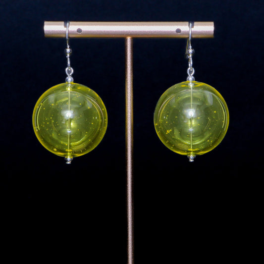 Lime yellow handblown glass earrings against a black background